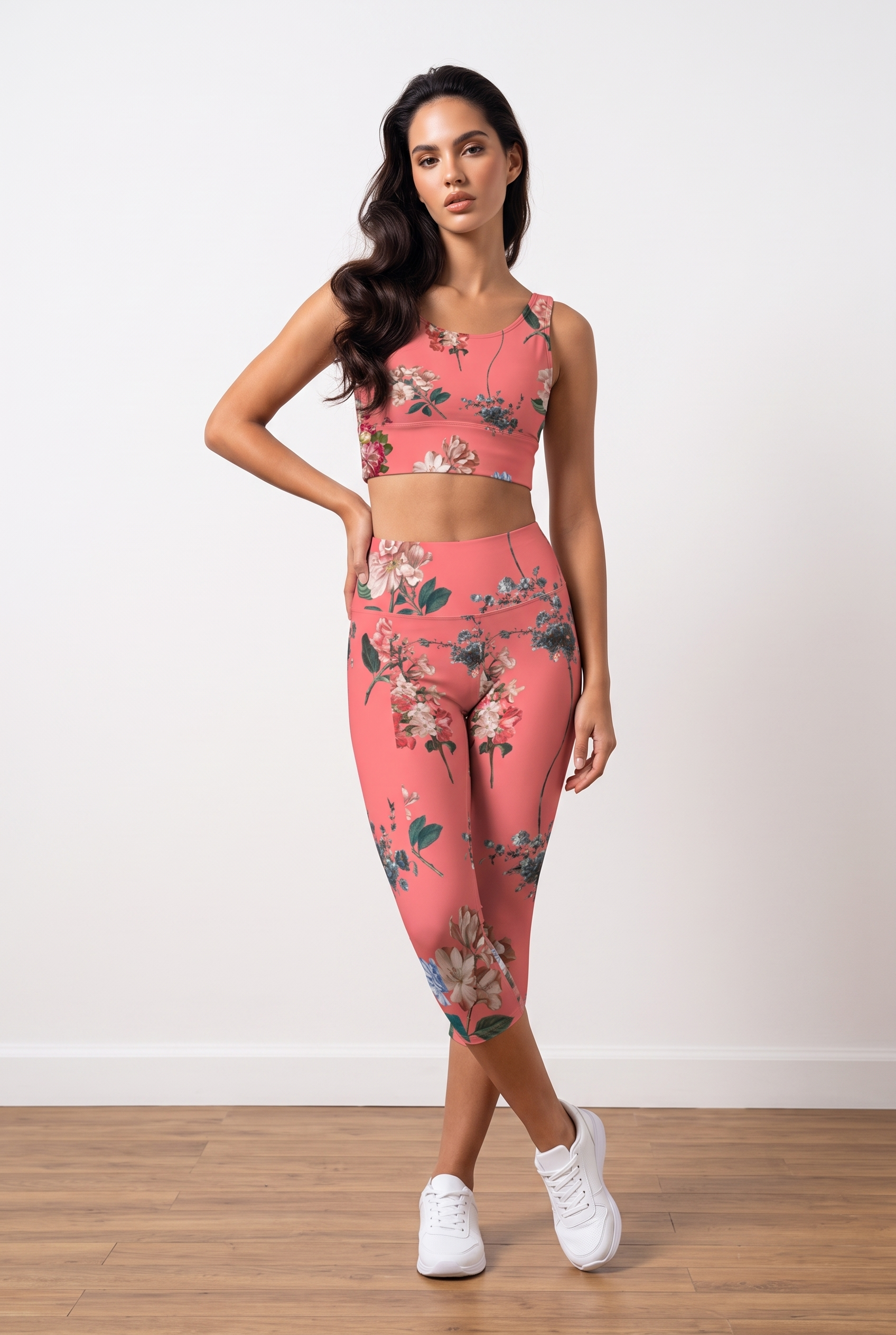 Coral iSquared Crop Top with a floral print, worn with matching leggings. Model poses confidently in white sneakers.