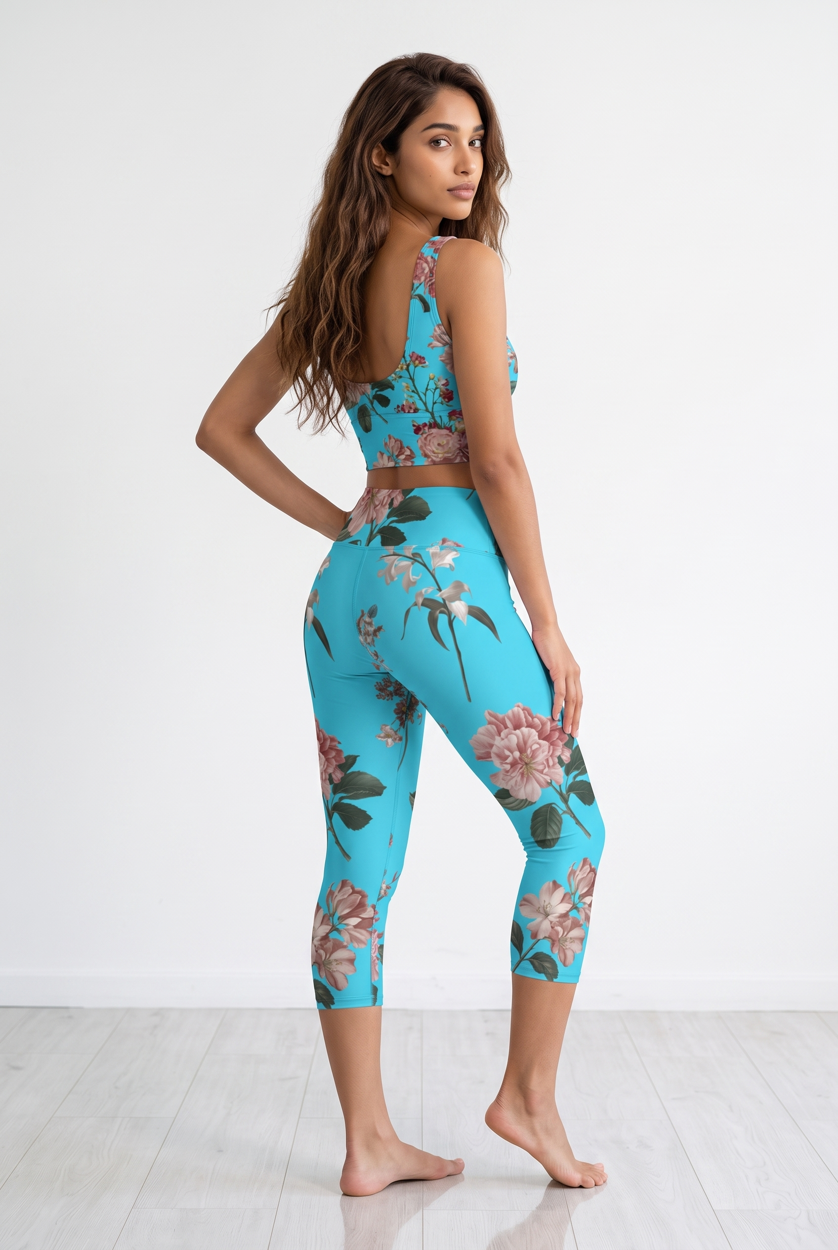 Cropped turquoise iSquared Crop Top featuring a floral print, paired with matching leggings, model posed from the back.