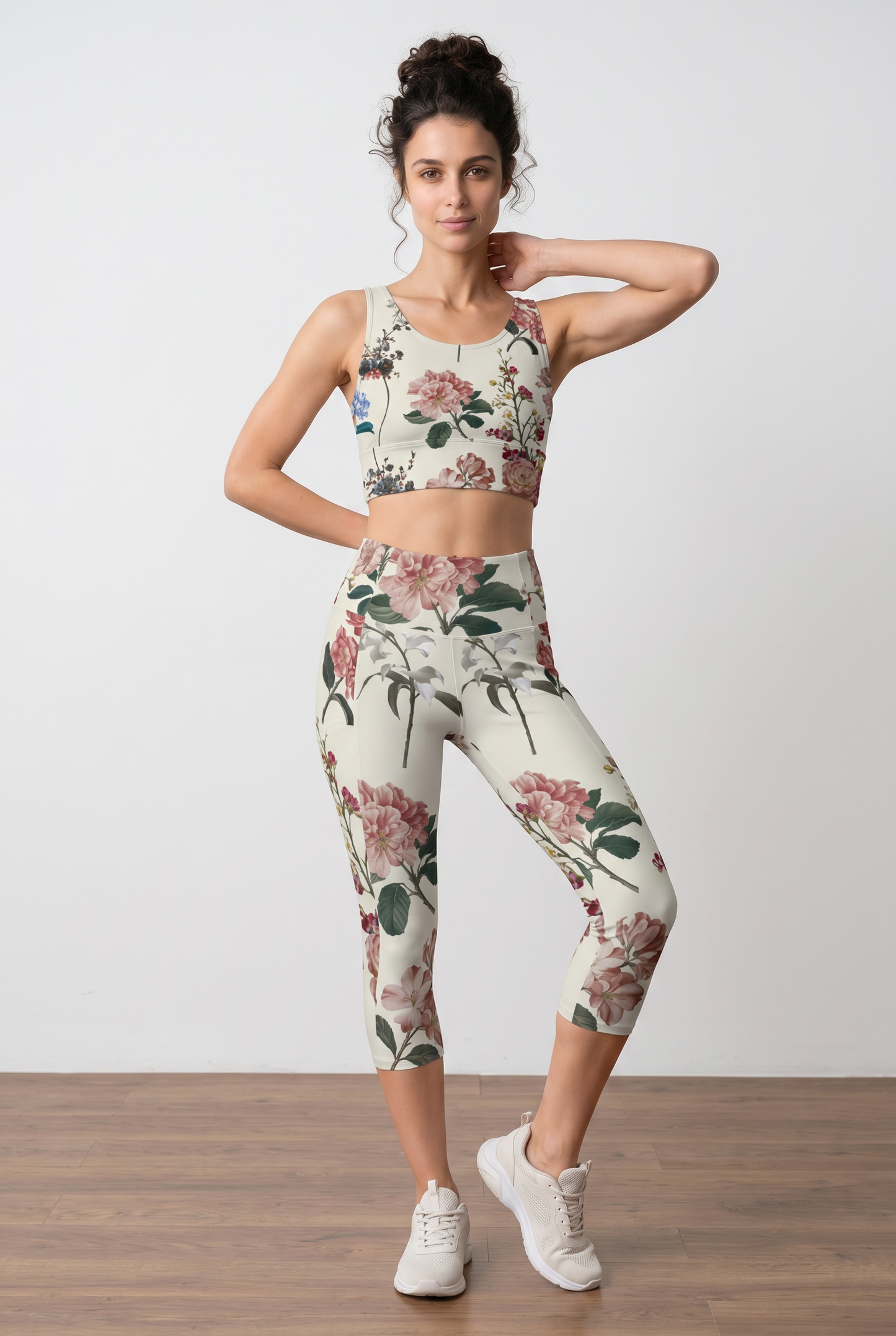 Cropped floral top in beige with colorful botanical prints, paired with matching leggings, model poses confidently.